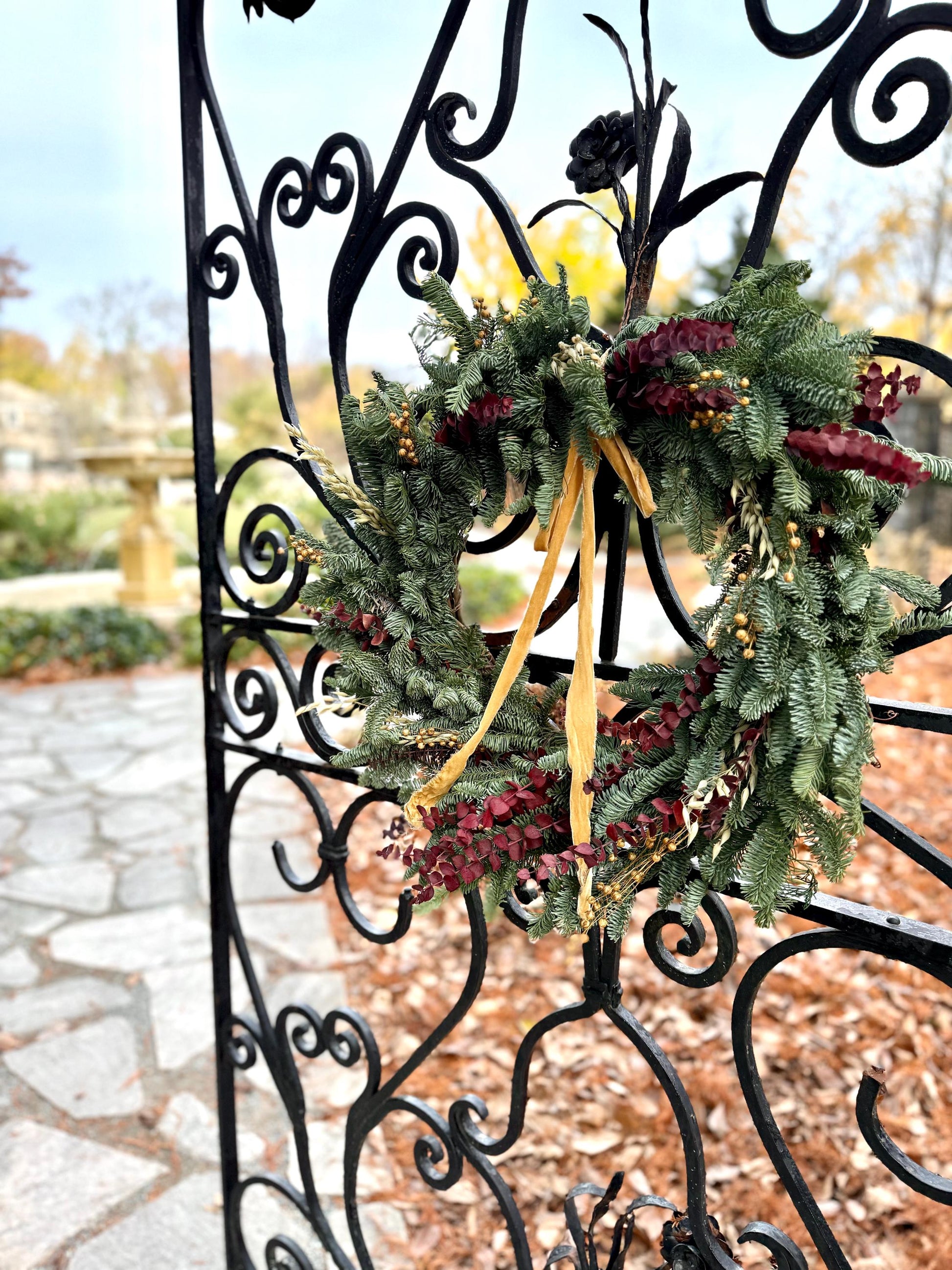 Holiday wreath featuring fresh noble fir, preserved eucalyptus, dried flax and  a gorgeous gold velvet ribbon. 
Adorn a wall, mantel or sheltered door; this fresh, dried and preserved wreath is the perfect way to add beauty to your space.
