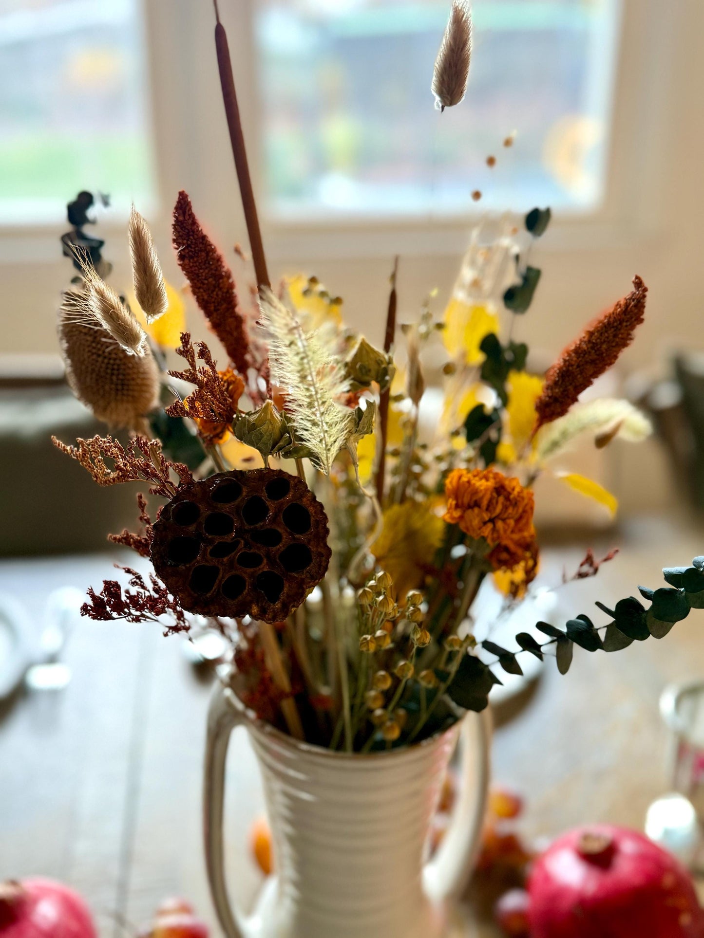 The Blissful bouquet is a stunning Fall inspired bouquet featuring preserved eucalyptus and magnolia, dried marigolds, millet, flax, pods and bunny tails. Stunning as a centerpiece for your Thanksgiving table or all year round for the Fall lovers.