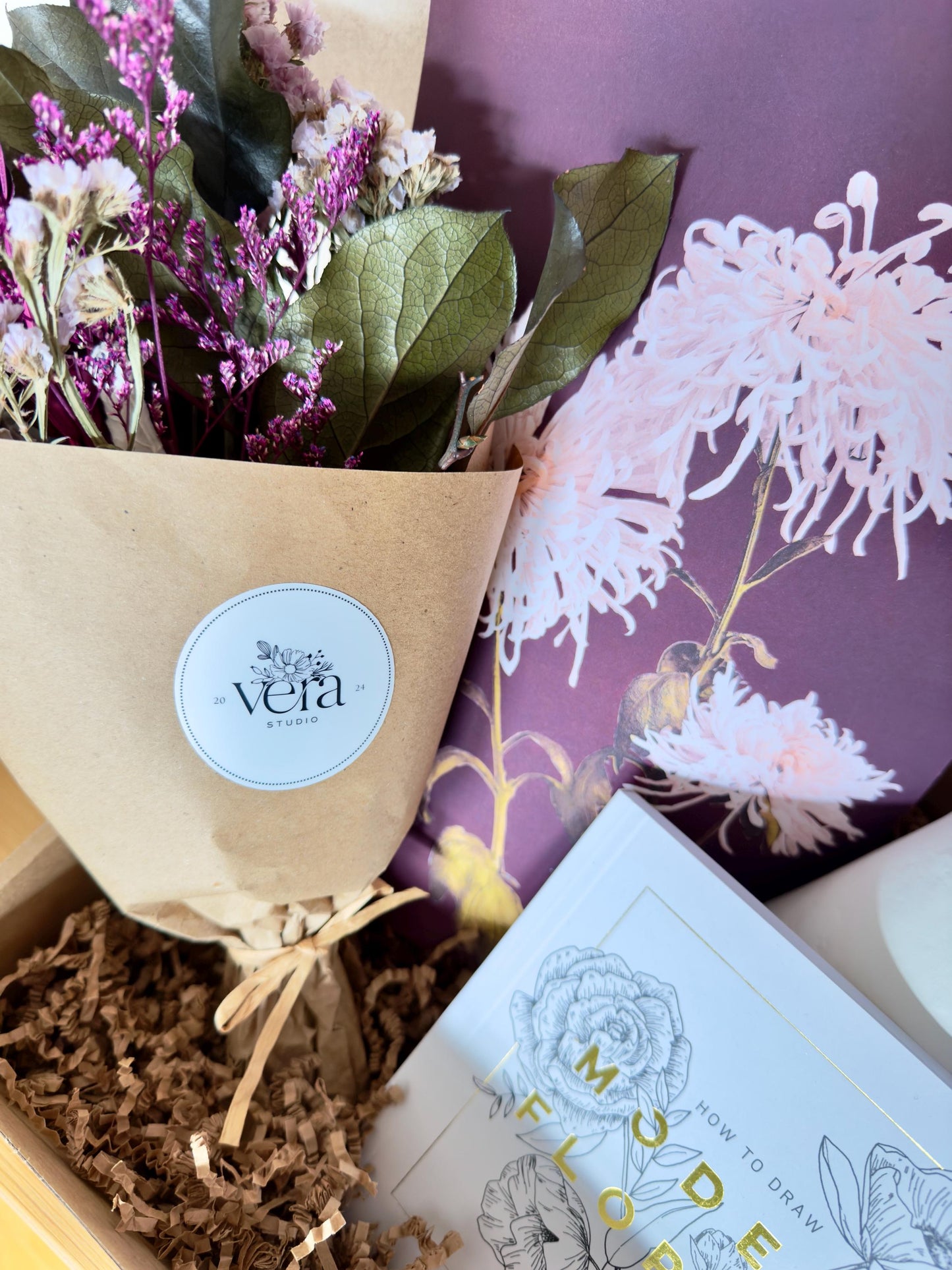 Gift box that includes a dried bouquet by Vera Studio, paper mache vase, modern flowers drawing book, print by Ogawa Kazumasa and flower bouquet sticker by Artist Megan Morole.
